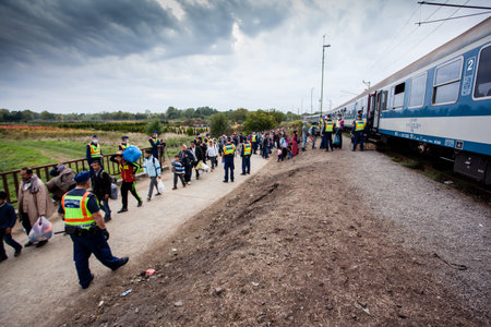 GYEKENYES- OCTOBER 6 : War refugees at the Gyekenyes Zakany Railway Station on 6 October 2015 in...
