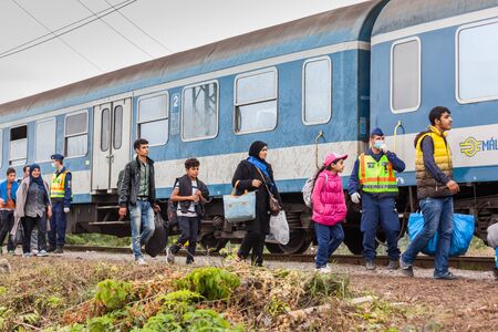 GYEKENYES- OCTOBER 6 : War refugees at the Gyekenyes Zakany Railway Station on 6 October 2015 in Gyekenyes, Hungary. Refugees are arriving constantly to Hungary on the way to Germany.のeditorial素材