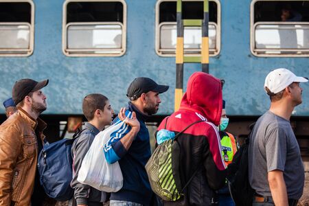 GYEKENYES- OCTOBER 5 : War refugees at the Gyekenyes Zakany Railway Station on 5 October 2015 in Gyekenyes, Hungary. Refugees are arriving constantly to Hungary on the way to Germany.のeditorial素材