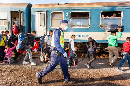 GYEKENYES- OCTOBER 5 : War refugees at the Gyekenyes Zakany Railway Station on 5 October 2015 in Gyekenyes, Hungary. Refugees are arriving constantly to Hungary on the way to Germany.のeditorial素材