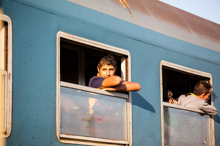 GYEKENYES- OCTOBER 5 : War refugees at the Gyekenyes Zakany Railway Station on 5 October 2015 in Gyekenyes, Hungary. Refugees are arriving constantly to Hungary on the way to Germany.のeditorial素材