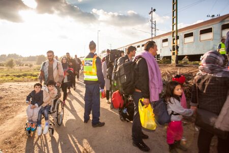 GYEKENYES- OCTOBER 5 : War refugees at the Gyekenyes Zakany Railway Station on 5 October 2015 in Gyekenyes, Hungary. Refugees are arriving constantly to Hungary on the way to Germany.のeditorial素材