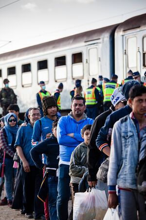 GYEKENYES- OCTOBER 5 : War refugees at the Gyekenyes Zakany Railway Station on 5 October 2015 in Gyekenyes, Hungary. Refugees are arriving constantly to Hungary on the way to Germany.のeditorial素材