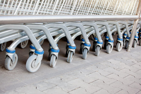 Row of supermarket shopping cart trolleys