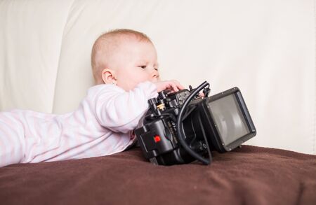 Baby girl playing with underwater cameraの写真素材