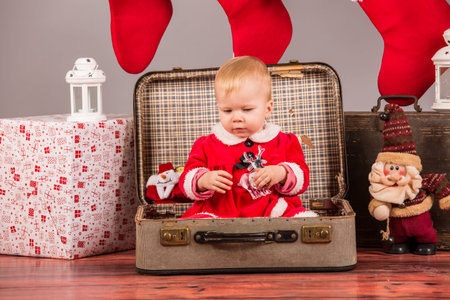 baby santa girl with christimas decoration in studioの写真素材