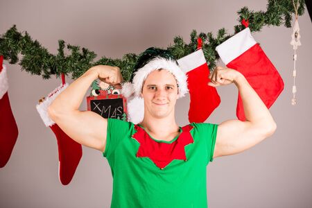 Funny Christmas elf in green suitsの写真素材