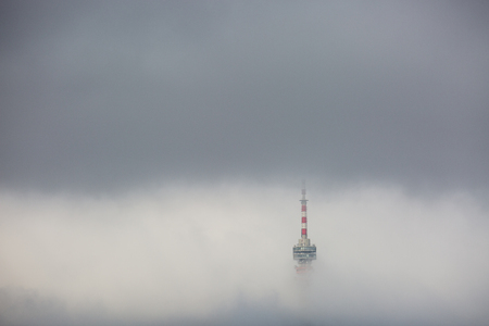 Telecommunication Tower in foggy and cloudy skyの写真素材