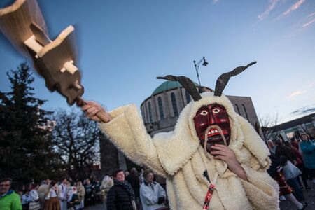 MOHACS, HUNGARY - MARCH 5: Unidentified people in mask participants at the Mohacsi Busojaras, it is a carnival for spring greetings March 5, 2019 in Mohacs, Hungaryのeditorial素材