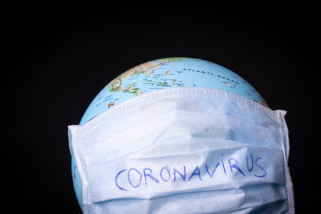 medical mask on a globe for coronavirus protectionの写真素材