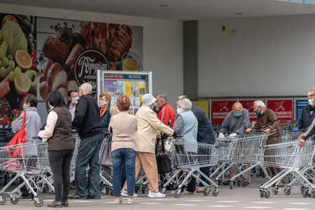 PECS - MAY 27 : Old people go to shopping on the street  on 27 May 2020 in Pecs, Hungary. During coronavirus pandemic, everybody have to waering face maskのeditorial素材