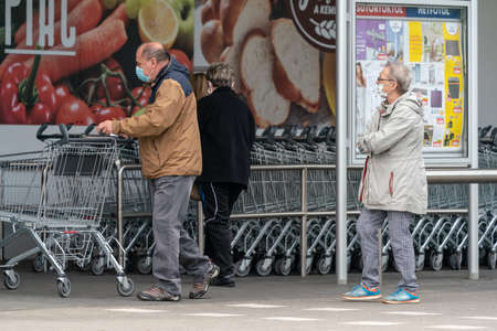 PECS - MAY 27 : Old people go to shopping on the street  on 27 May 2020 in Pecs, Hungary. During coronavirus pandemic, everybody have to waering face maskのeditorial素材