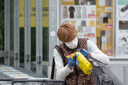 PECS - MAY 27 : Old woman go to shopping on the street  on 27 May 2020 in Pecs, Hungary. During coronavirus pandemic, everybody have to waering face maskのeditorial素材