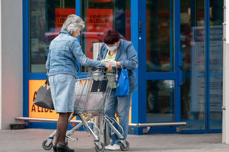 PECS - MAY 27 : Old people go to shopping on the street  on 27 May 2020 in Pecs, Hungary. During coronavirus pandemic, everybody have to waering face maskのeditorial素材