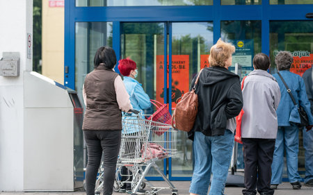 PECS - MAY 27: Old people go shopping on the street on May 27, 2020 in Pecs, Hungary. During...