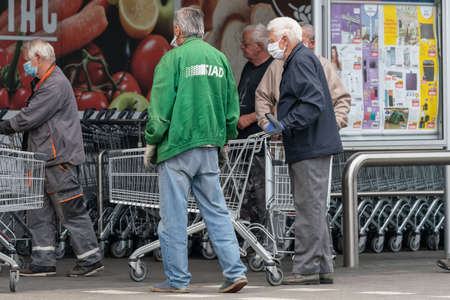 PECS - MAY 27: Old people go shopping on the street on May 27, 2020 in Pecs, Hungary. During coronavirus pandemic, everybody have to waering face maskのeditorial素材