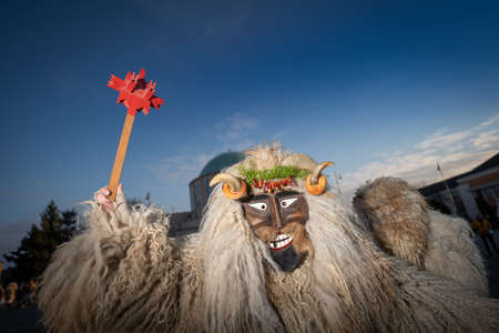 MOHACS, HUNGARY - FEBRUARY 14: Unidentified person wearing mask for spring greetings. In this year during the COVID pandemic the public Busojaras event was canceled. February 14, 2021 in Mohacs, Hungary.のeditorial素材