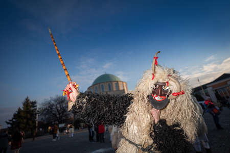 MOHACS, HUNGARY - FEBRUARY 14: Unidentified person wearing mask for spring greetings. In this year during the COVID pandemic the public Busojaras event was canceled. February 14, 2021 in Mohacs, Hungary.のeditorial素材