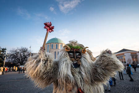 MOHACS, HUNGARY - FEBRUARY 14: Unidentified person wearing mask for spring greetings. In this year during the COVID pandemic the public Busojaras event was canceled. February 14, 2021 in Mohacs, Hungary.のeditorial素材
