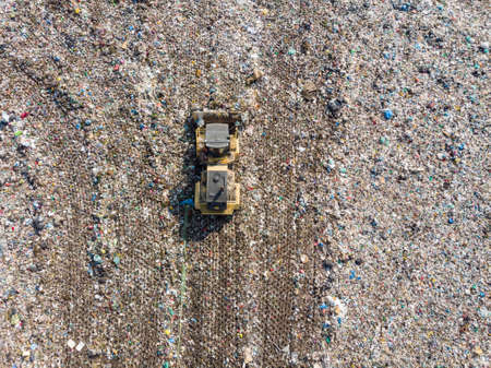 Garbage trucks unload garbage to a landfillの写真素材