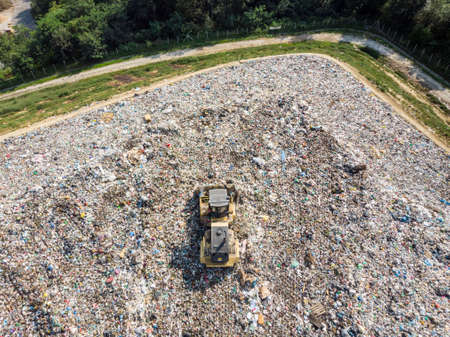 Garbage trucks unload garbage to a landfillの写真素材