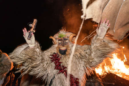 MOHACS, HUNGARY - MARCH 01: Unidentified person wearing mask for spring greetings. In this year during the COVID pandemic the public Busojaras event was canceled. March 01, 2022 in Mohacs, Hungary.のeditorial素材