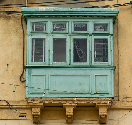 Traditional house detail in Malta. Limestone yellow bricks and colorful balconies, windowsの写真素材