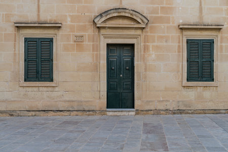 Traditional house detail in Malta. Limestone yellow bricks and colorful balconies, windowsの写真素材