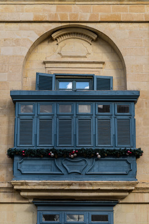 Traditional house detail in Malta. Limestone yellow bricks and colorful balconies, windowsの写真素材
