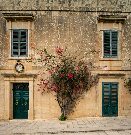 Traditional house detail in Malta. Limestone yellow bricks and colorful balconies, windowsの写真素材