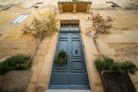 Traditional house detail in Malta. Limestone yellow bricks and colorful balconies, windowsの写真素材