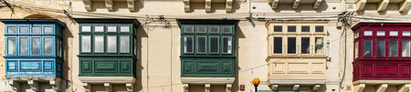 Traditional house detail in Malta. Limestone yellow bricks and colorful balconies, windowsの写真素材