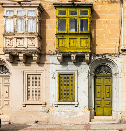 Traditional house detail in Malta. Limestone yellow bricks and colorful balconies, windowsの写真素材