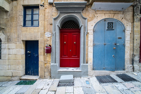 Traditional house detail in Malta. Limestone yellow bricks and colorful balconies, windowsの写真素材