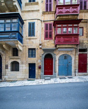 Traditional house detail in Malta. Limestone yellow bricks and colorful balconies, windowsの写真素材