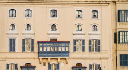 Traditional house detail in Malta. Limestone yellow bricks and colorful balconies, windowsの写真素材