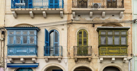 Traditional house detail in Malta. Limestone yellow bricks and colorful balconies, windowsの写真素材