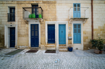Traditional house detail in Malta. Limestone yellow bricks and colorful balconies, windowsの写真素材