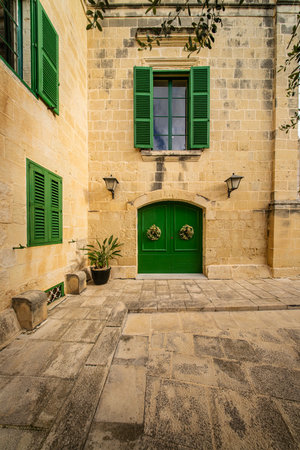 Traditional house detail in Malta. Limestone yellow bricks and colorful balconies, windowsの写真素材