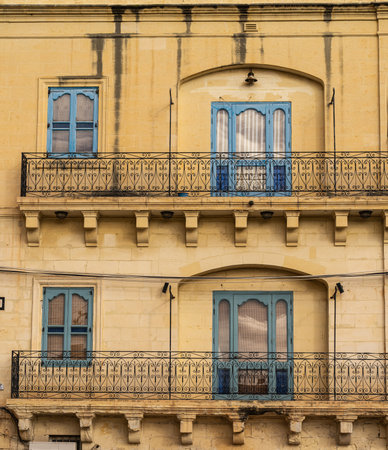 Traditional house detail in Malta. Limestone yellow bricks and colorful balconies, windowsの写真素材