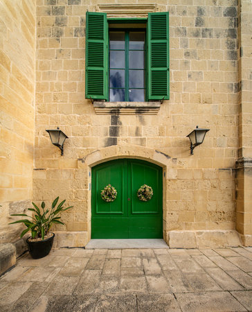 Traditional house detail in Malta. Limestone yellow bricks and colorful balconies, windowsの写真素材