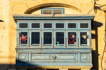 Traditional house detail in Malta. Limestone yellow bricks and colorful balconies, windowsの写真素材