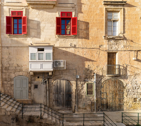 Traditional house detail in Malta. Limestone yellow bricks and colorful balconies, windowsの写真素材
