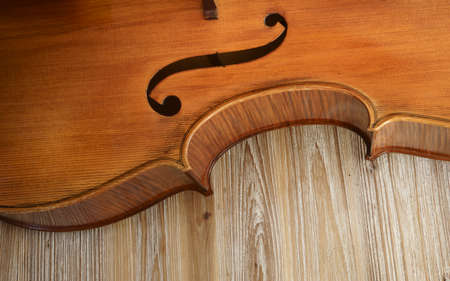 Detail of the acoustic panel of a cello on wooden tableの写真素材