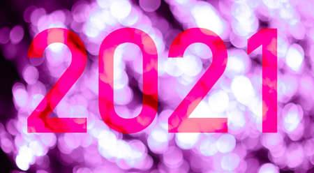 Text with the number of the year 2021 with a background of bright lights out of focus in pink tones. Happy New Year 2021.の写真素材