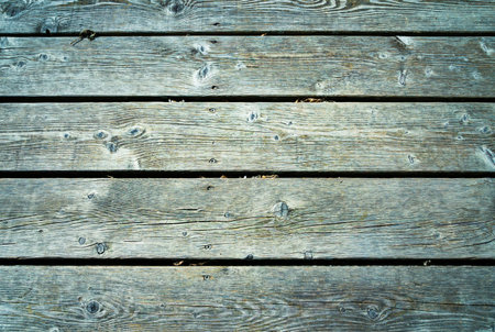 Old wooden planks with bluish tones and lots of texture placed horizontally.の写真素材