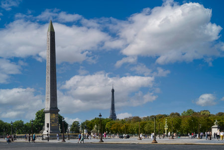 View of the Place de la Concorde in Paris with the obelisk of Luxor and the Eiffel Tower in the background on a summer day with blue sky and white clouds.のeditorial素材