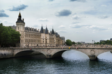 View of the Pont au Change over the Seine River in Paris with La Conciergerie and the Clock Tower in the background.のeditorial素材
