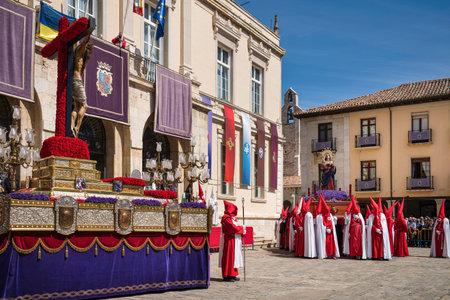 Holy Week in Palencia, Spain. Penitents carrying the image of Jesus Christ on the cross through the...