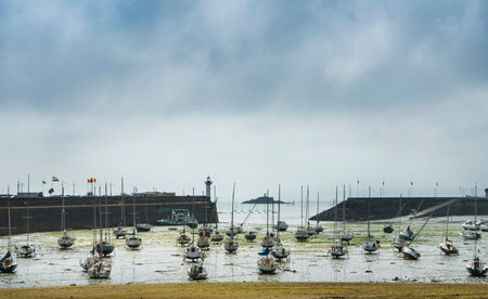 View of the harbor at low tide in the French town of Saint Quay Portrieux with stranded ships.のeditorial素材